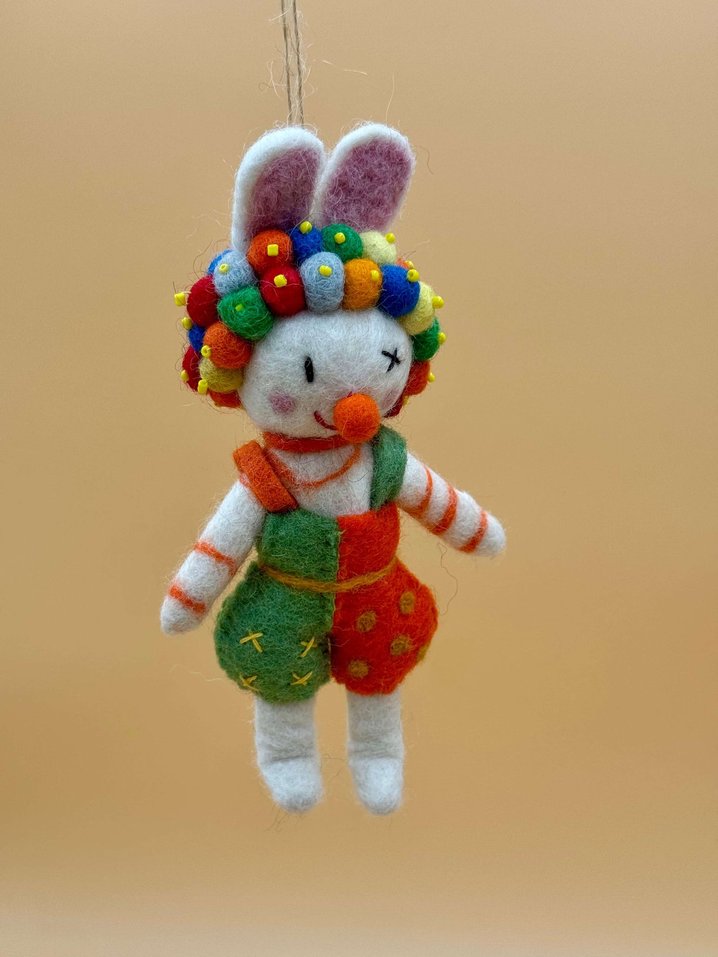 Handmade colorful clown keychain made of felt, featuring a bunny design with vibrant colors and playful details.