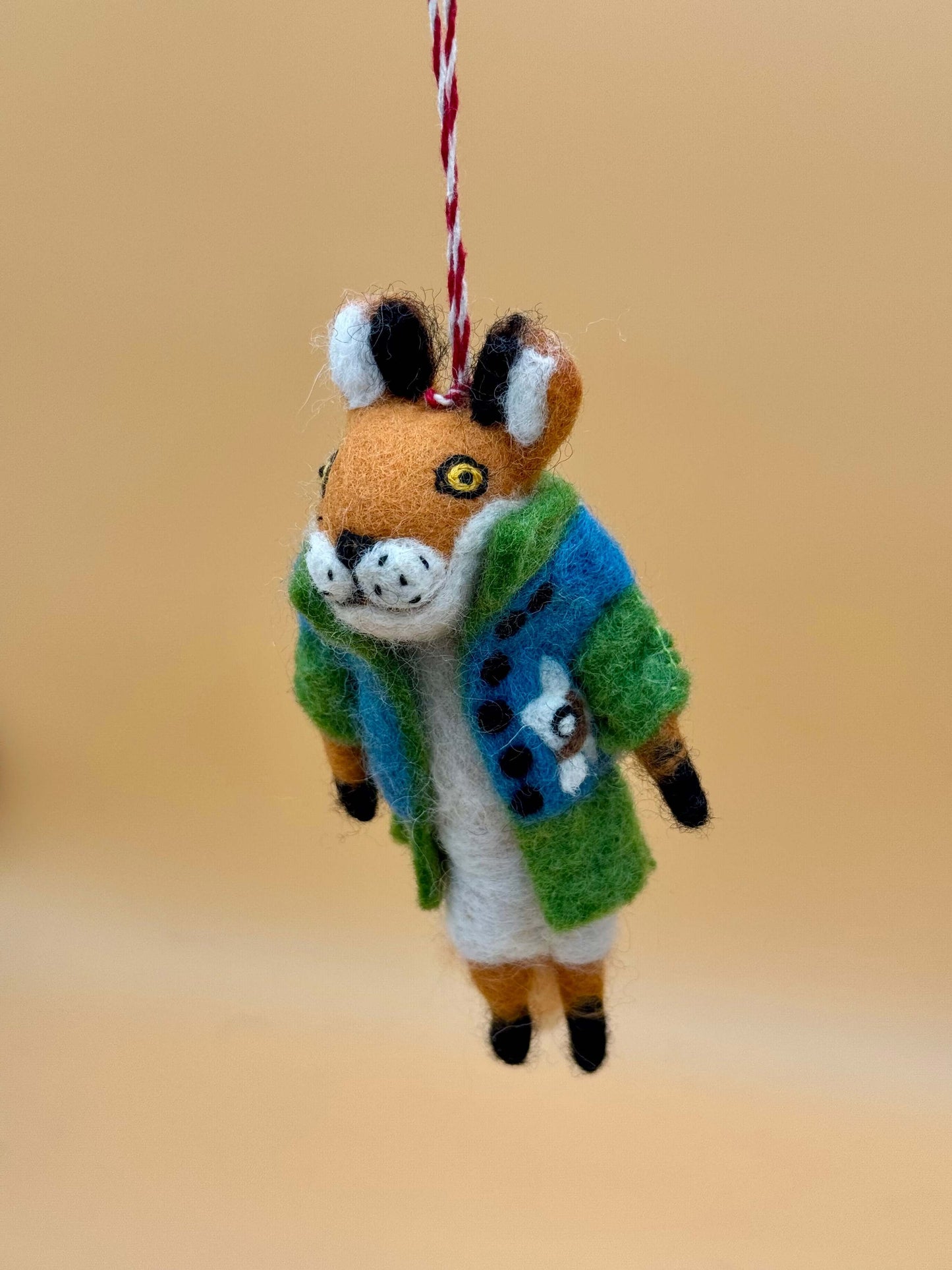 Handmade felt keychain in the shape of a fox wearing a jacket, featuring vibrant colors and intricate details.