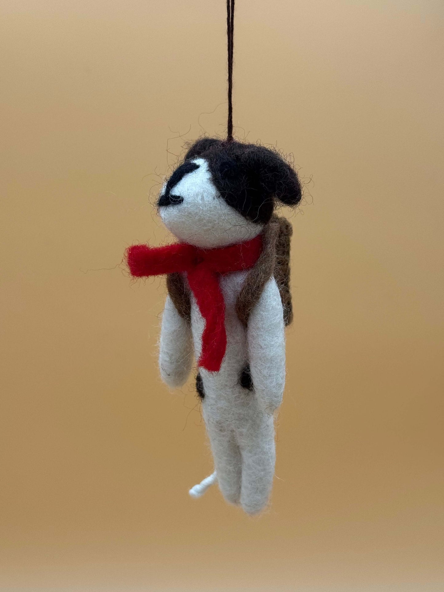 Handmade felt dog keychain with backpack and scarf, perfect for school, in white, black, and red colors.