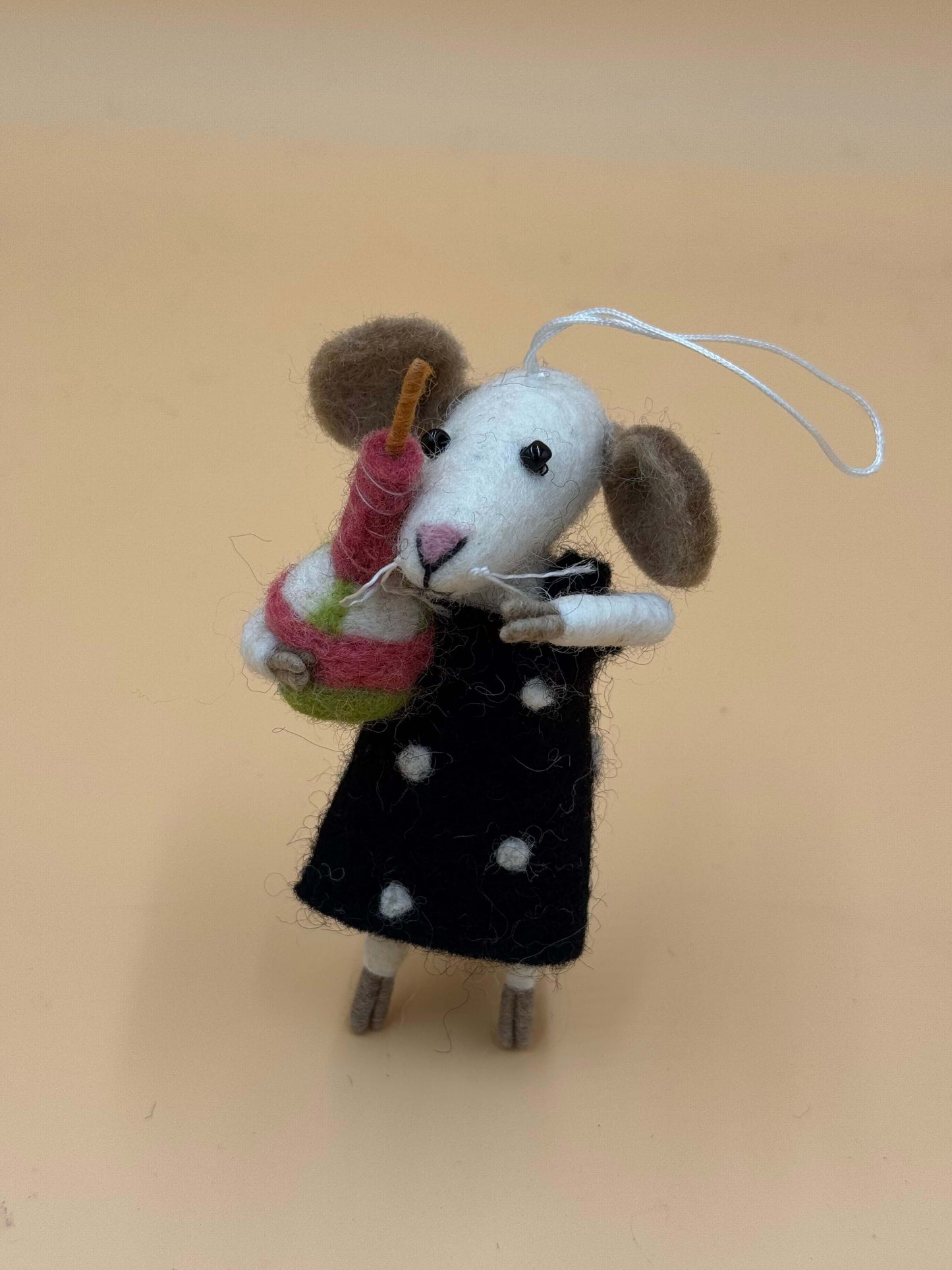 Handcrafted felt mouse keychain with cake, black dress, and polka dots. Perfect for cute accessory lovers!