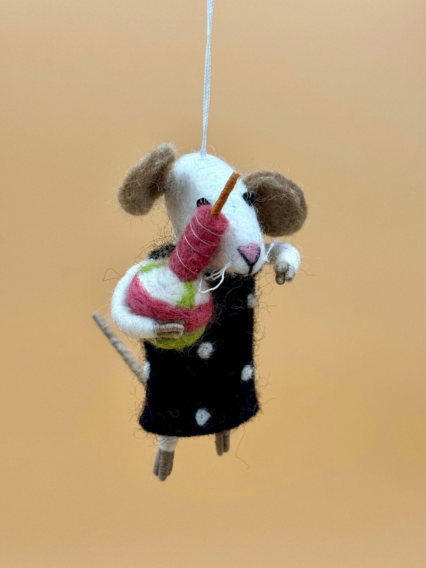 Handmade felt mouse keychain with cake, featuring a black polka dot outfit and colorful dessert.