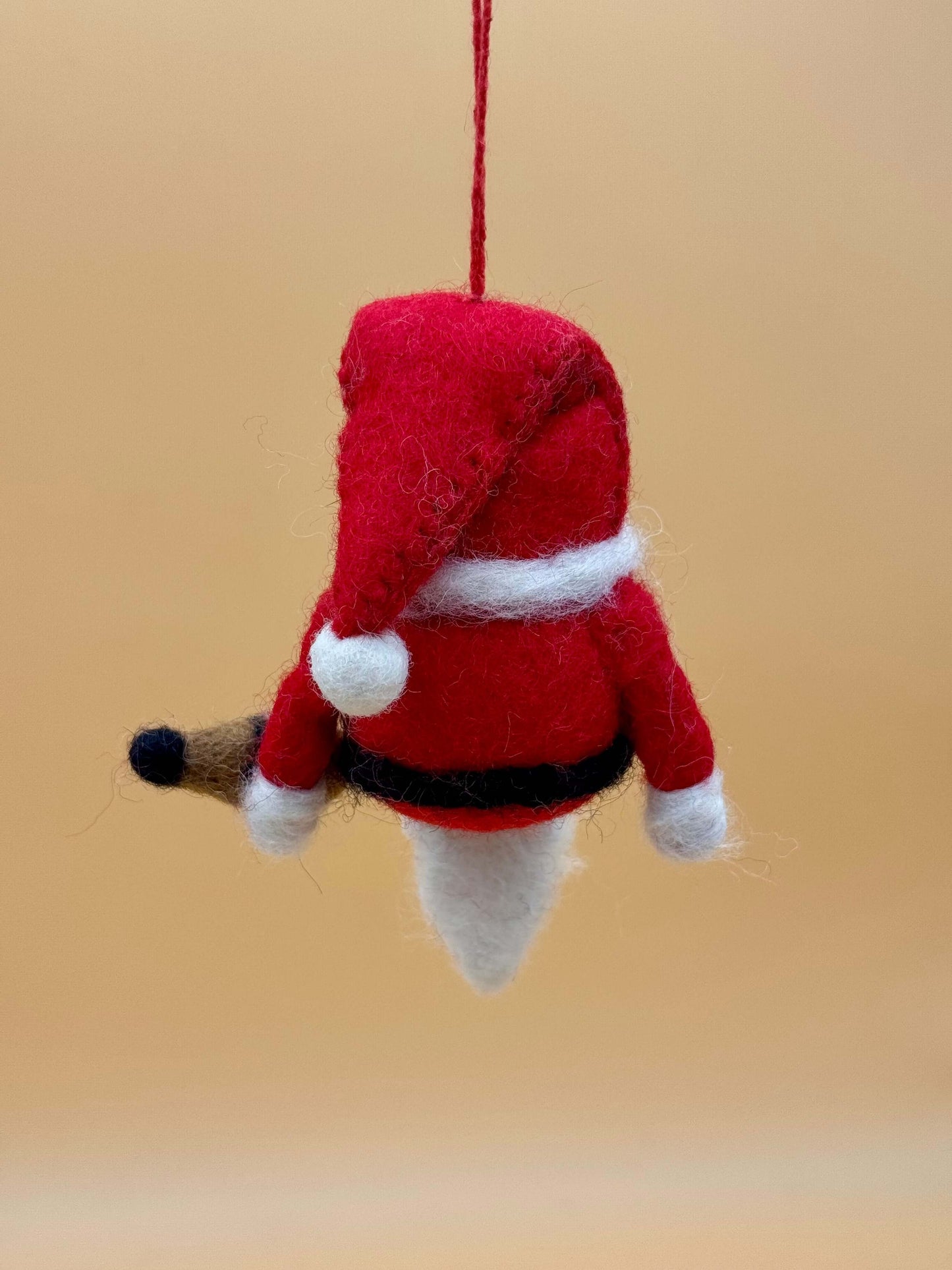 Handmade felt Santa ornament for Christmas decoration, featuring red, white, and black details, perfect as a keychain.