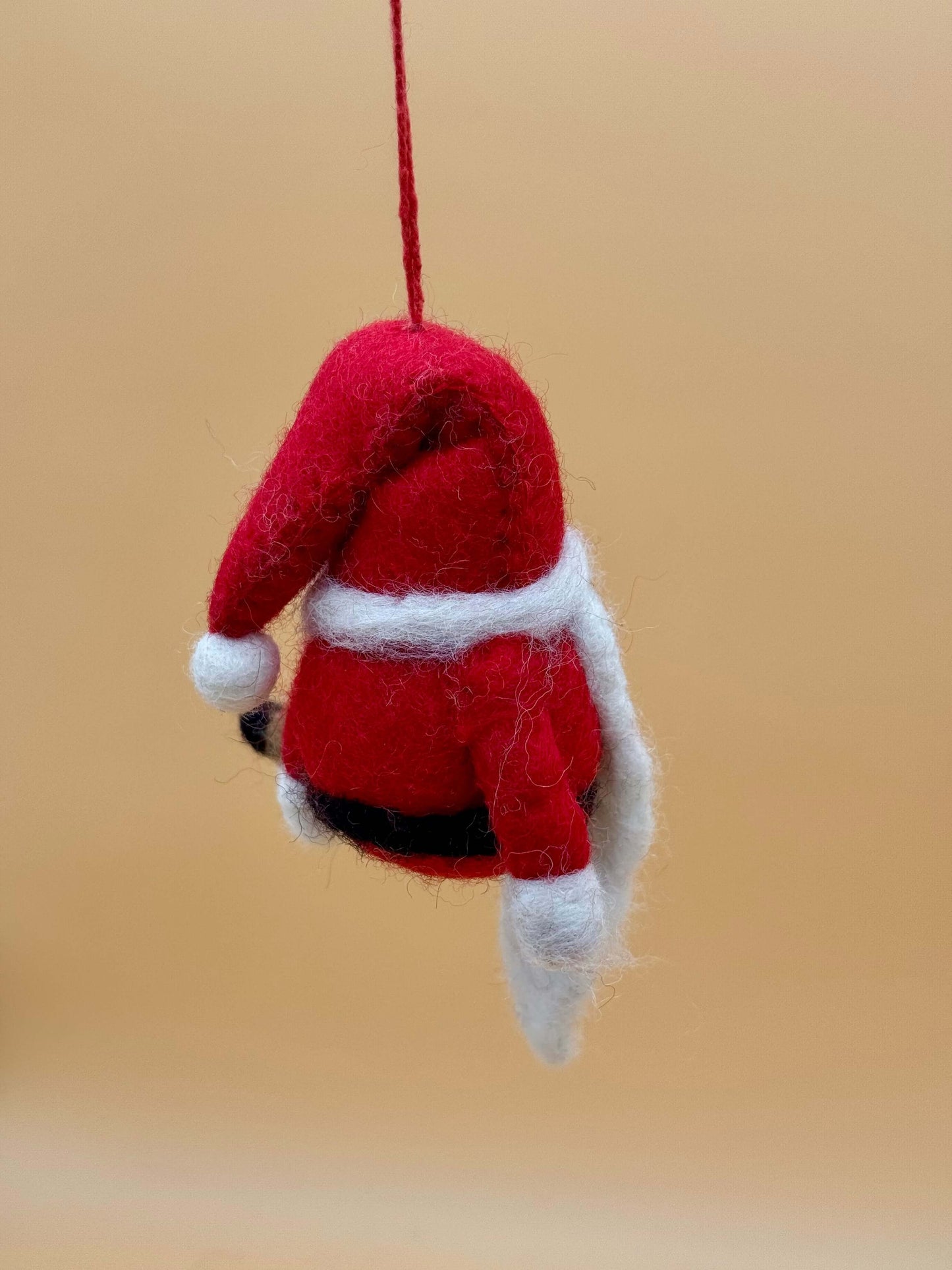 Handmade red and white felt Santa ornament, ideal as a Christmas tree decoration or gift.