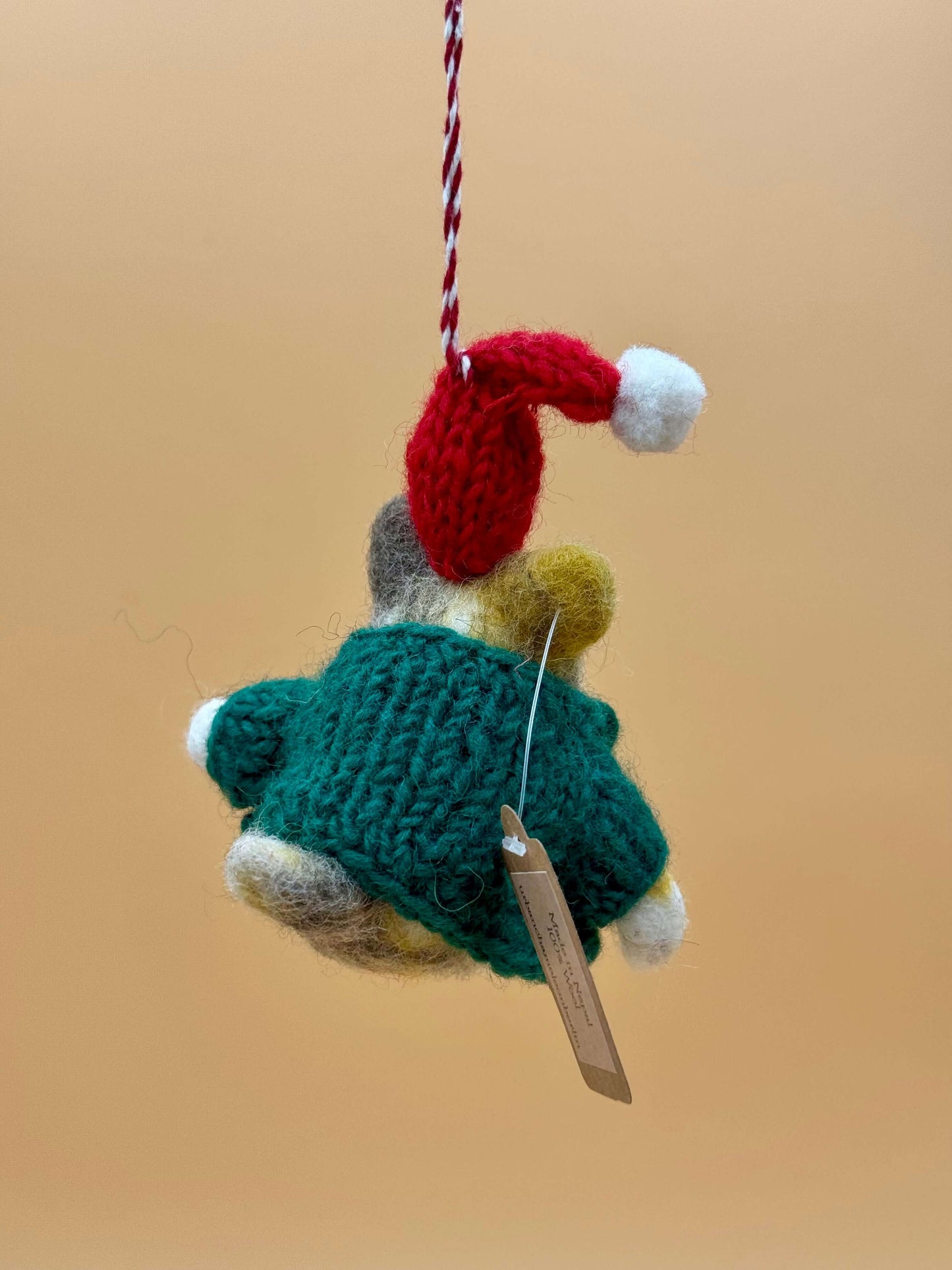 Handmade felt keychain of a Christmas mouse with red hat and green sweater, perfect holiday decoration.