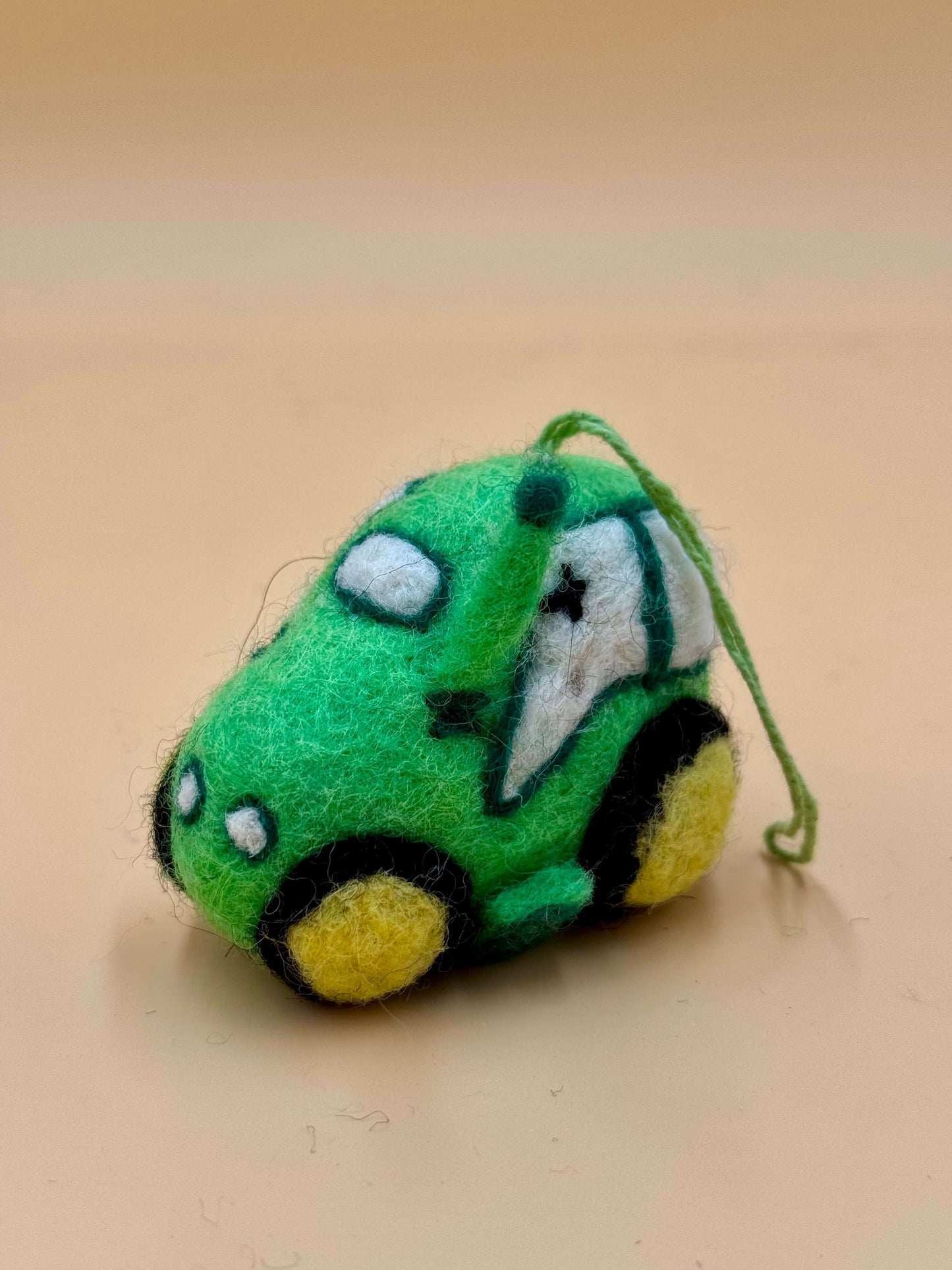 Filzanhänger Schlüsselanhänger in Form eines grünen Autos, handgefertigt aus 100% Wolle, einzigartiges Design.
