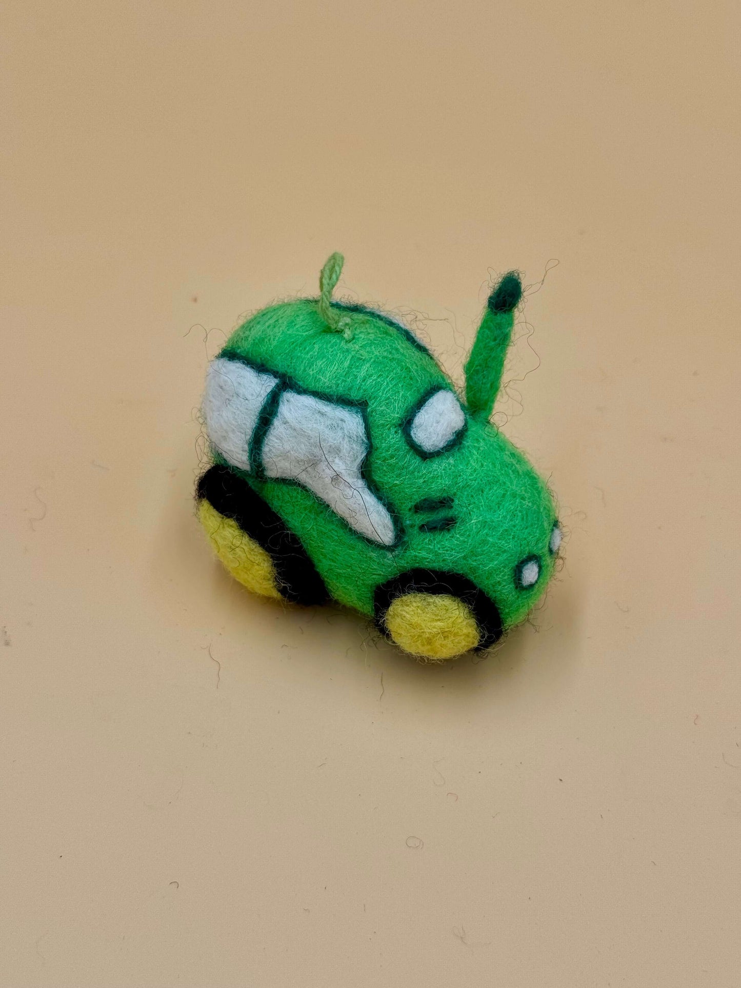 Handcrafted green felt car keychain, unique wool design, perfect for adding charm to your keys. View details for Filzanhänger.