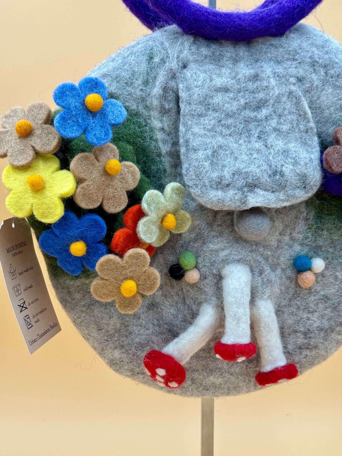 Handtasche Filztasche Size S Bucket Bag in grau mit bunten Filzblumen und einem Ring-Tragegriff.