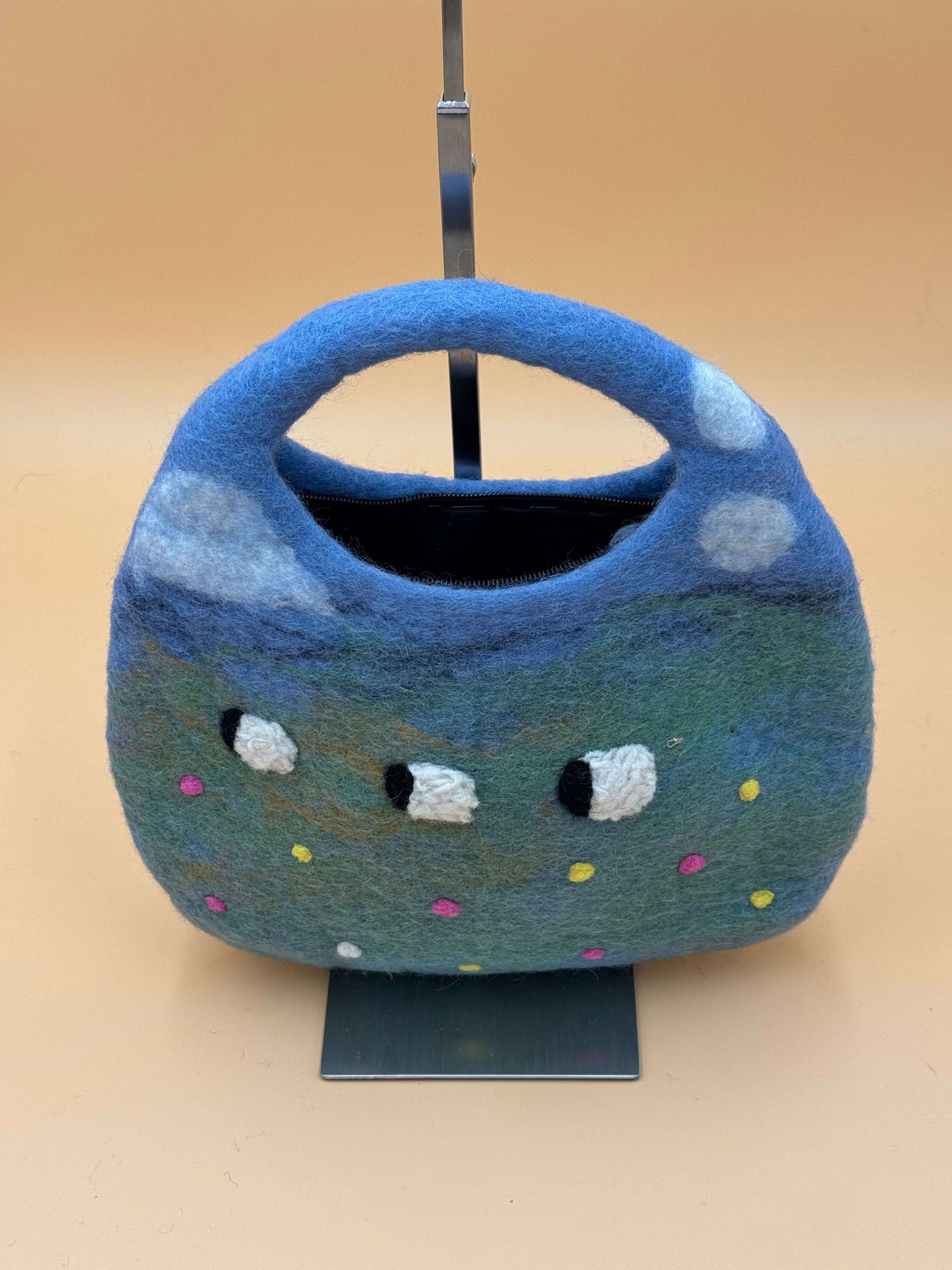Handmade felt Saddle Bag in blue and green with sheep design, featuring a zipper and interior lining for accessories.