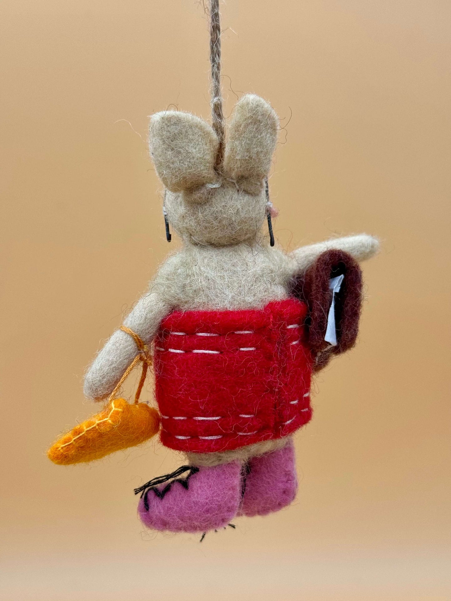 Handmade felt keychain: pig with dress, glasses, bag, and book in beige, brown, and red. Unique decor item.