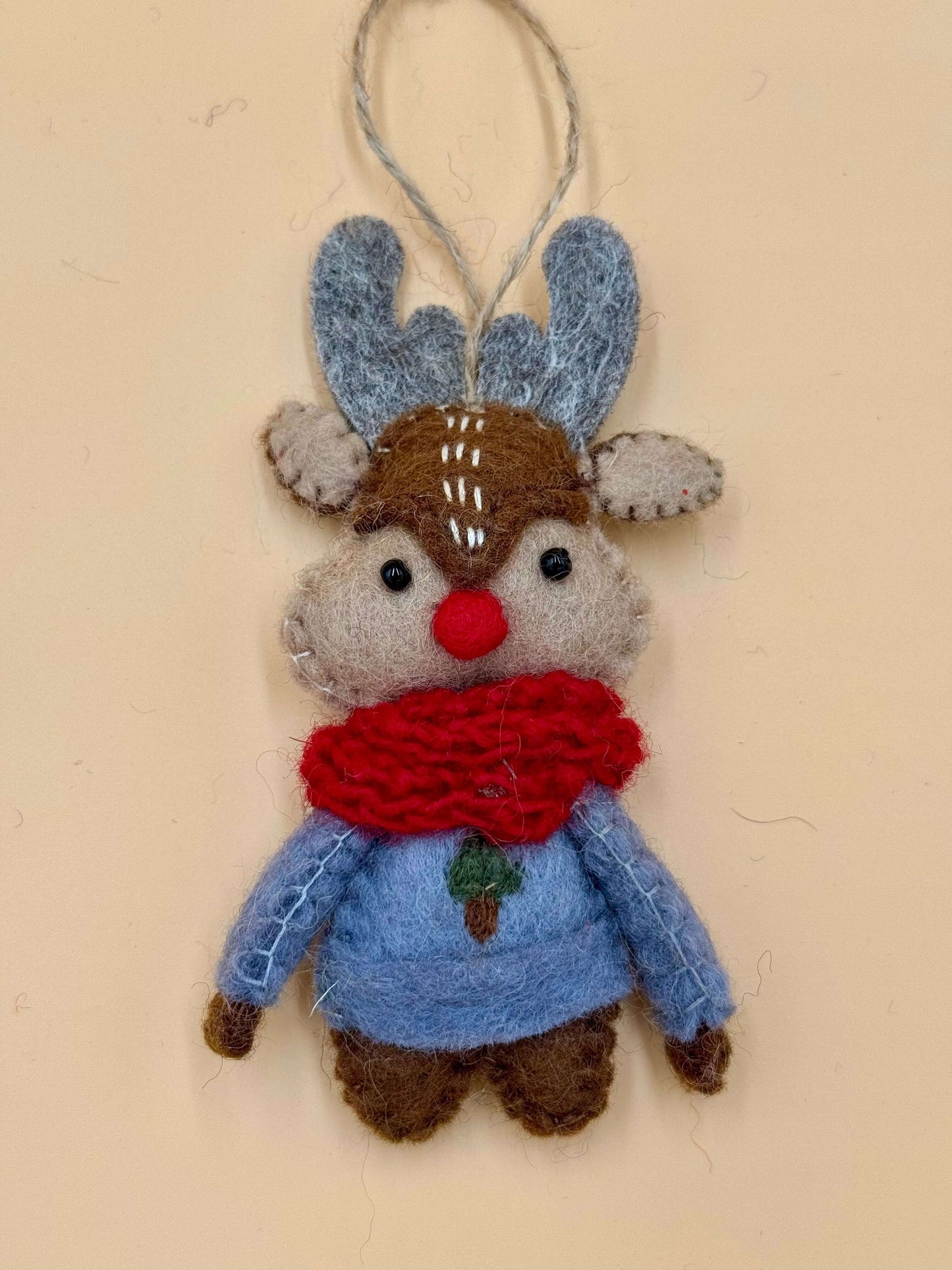 Handmade reindeer felt keychain with red scarf, blue shirt, and brown antlers, 100% wool