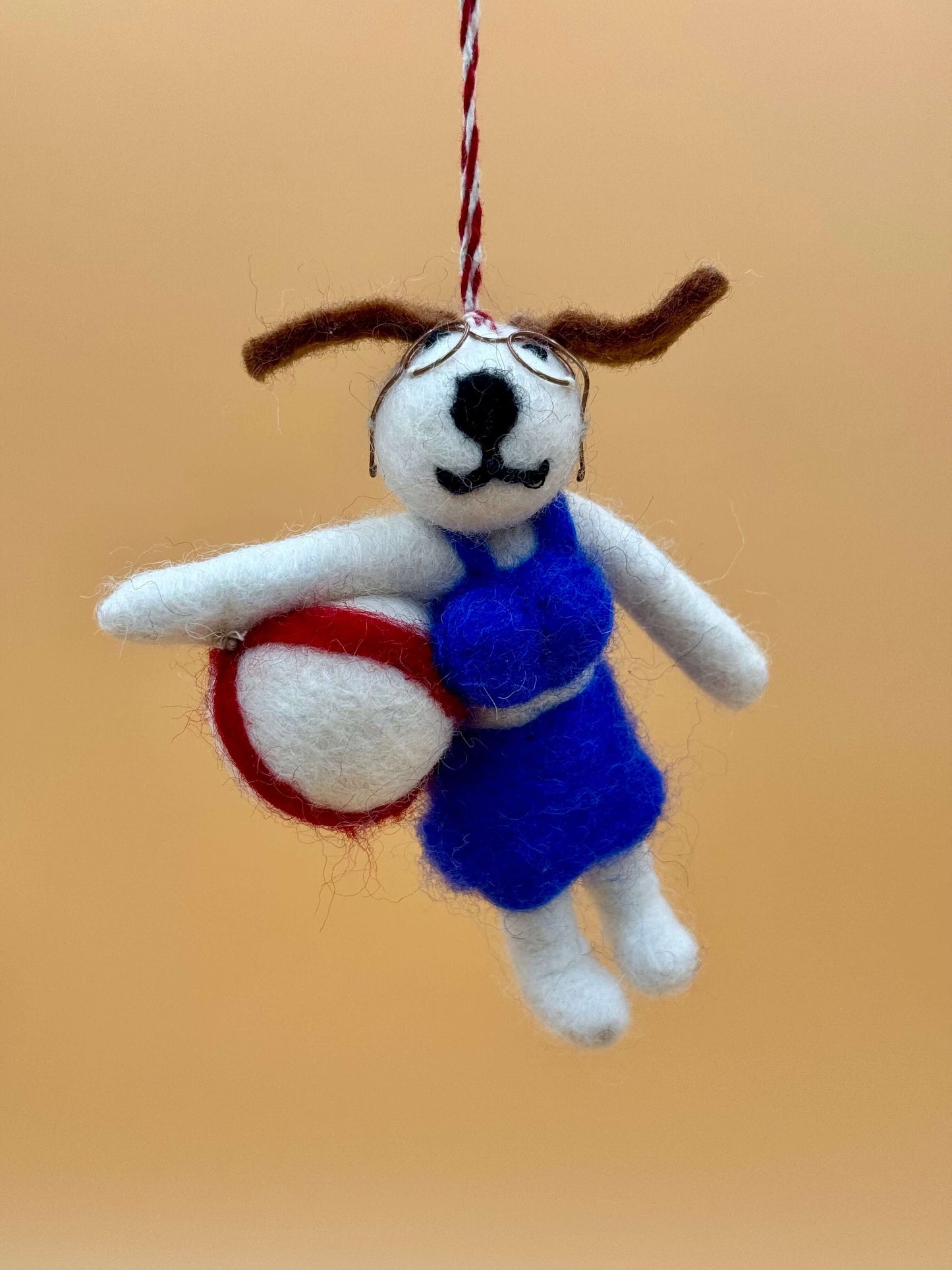 Handcrafted felt keychain featuring a dog in blue dress holding a volleyball, perfect as a unique accessory.