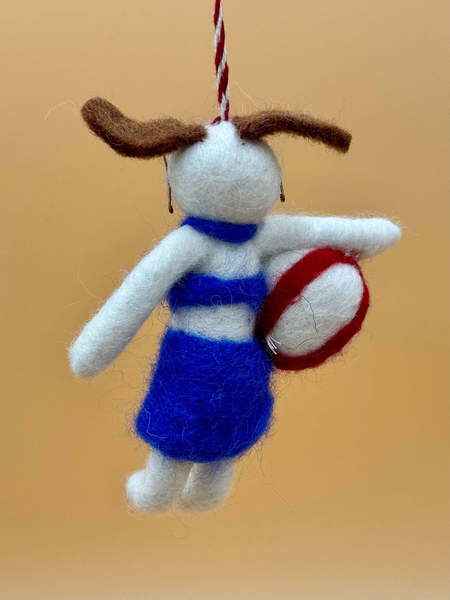 Handmade felt keyring of a dog in blue outfit holding a volleyball, unique design and crafted from 100% wool.