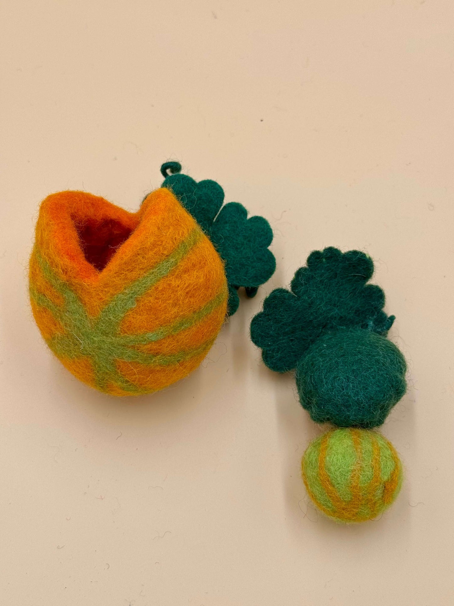 Handmade wool felt pumpkin keychain with green leaves, featuring a unique design perfect for girls.