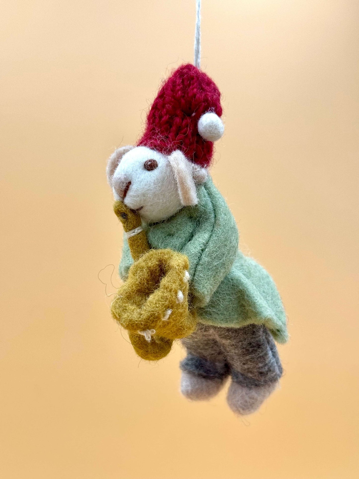 Handmade felt mouse keychain playing trumpet, green, red, and white, unique wool accessory. View details for Filzanhänger.