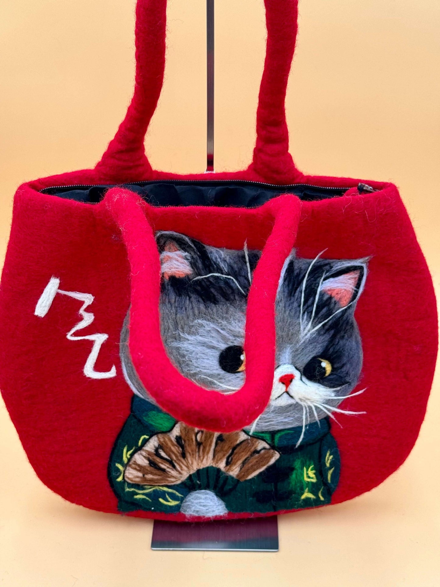 Handmade red felt shoulder bag featuring a cute cat design with fan, perfect for everyday use.