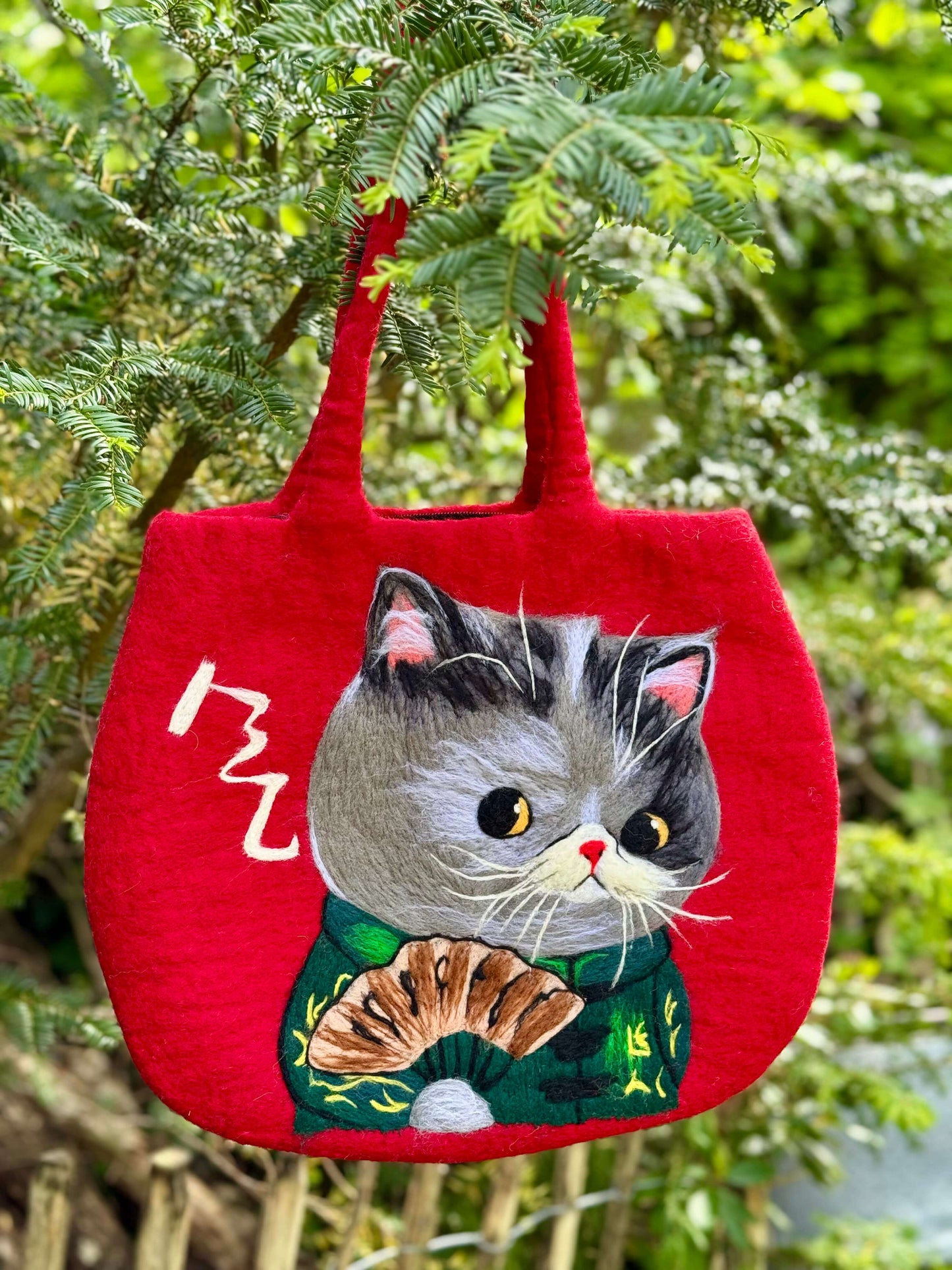 Handmade red felt shoulder bag with a cute kungfu cat design, perfect for carrying everyday items.