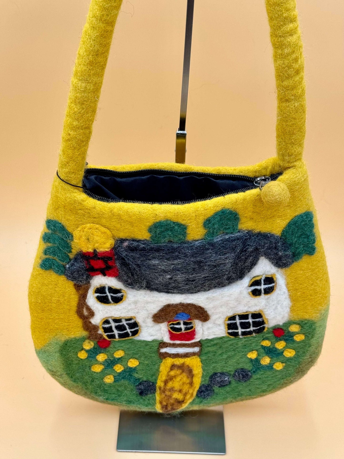 Handmade yellow felt shoulder bag with cottage design, featuring zipper and interior lining, ideal for daily use.