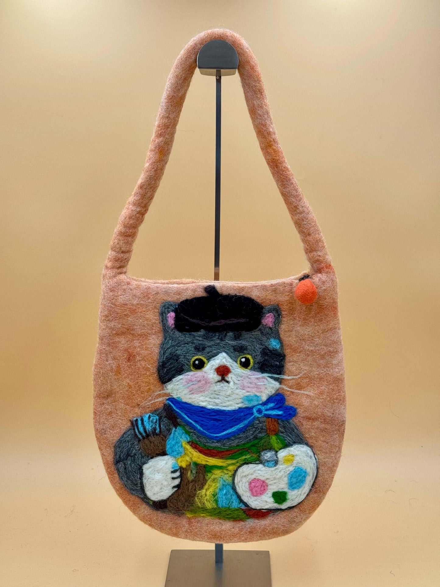 Handmade felt shoulder bag featuring a colorful cat design, measuring 28x29cm, in orange with black, gray, and blue details.