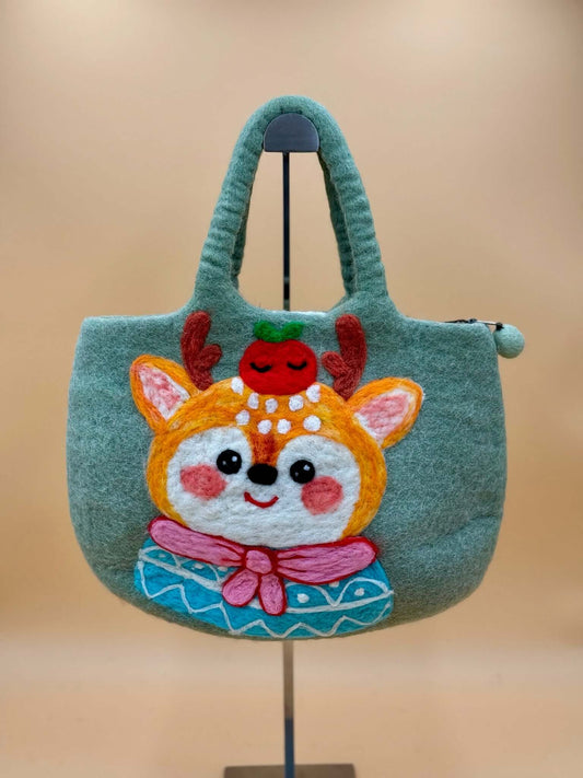 Handmade green felt tote bag with a cheerful deer design and apple on top, perfect for everyday use.