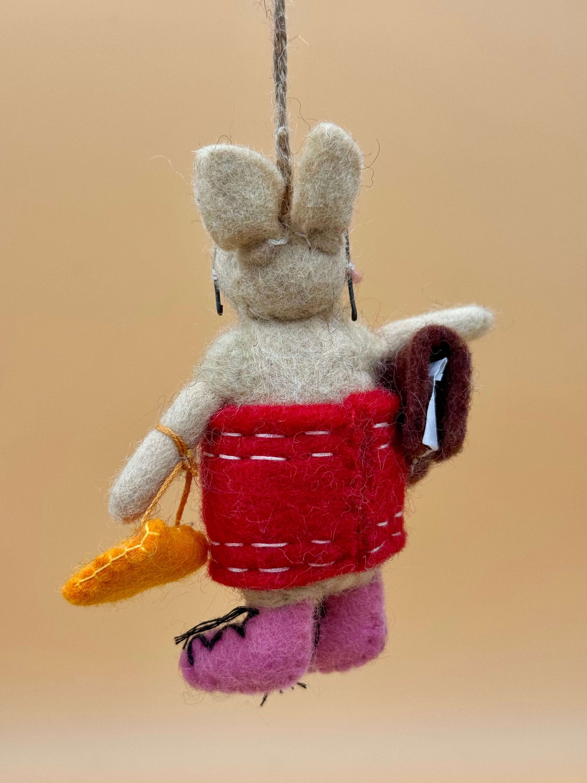 Handmade felt keychain: pig with dress, glasses, bag, and book in beige, brown, and red. Unique decor item.