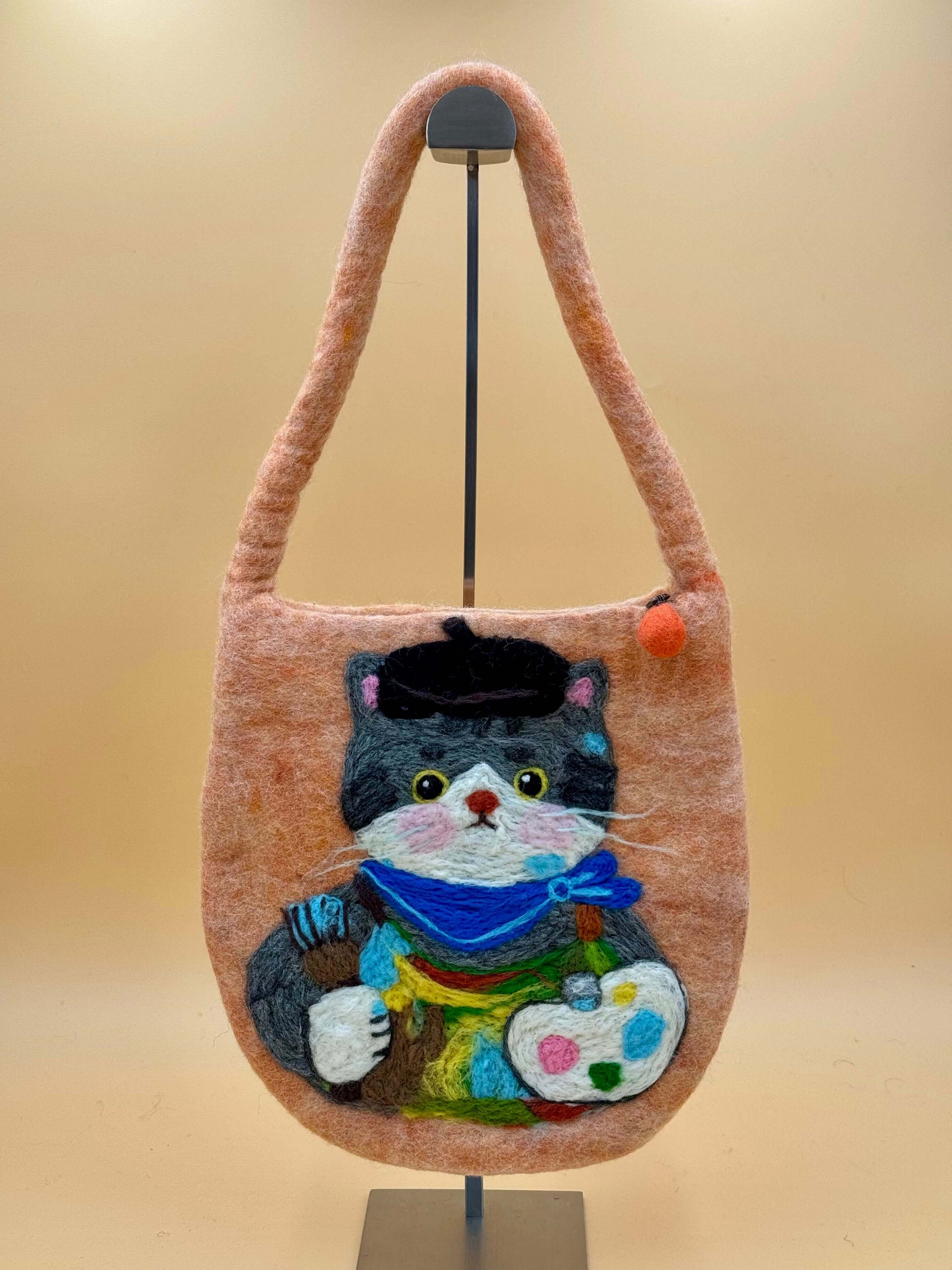 Handmade felt shoulder bag featuring a colorful cat design, measuring 28x29cm, in orange with black, gray, and blue details.